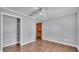 Bedroom featuring a ceiling fan, wood floors, neutral walls, and a closet at 3517 Ralston Rd, Plant City, FL 33566