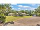 Wide shot of property featuring the single-story home, two garages, and a well-maintained lawn at 3517 Ralston Rd, Plant City, FL 33566