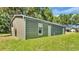 View of exterior of building with green lawn and blue sky at 3517 Ralston Rd, Plant City, FL 33566