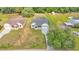 An aerial view of the house with a driveway and a luscious green lot at 12484 Green Oak Ln, Dade City, FL 33525