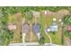 A bird's-eye view of multiple houses nestled amongst dense trees and lush greenery at 12484 Green Oak Ln, Dade City, FL 33525