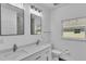 Bright bathroom with double sinks and large mirrors, providing ample space for morning routines at 12484 Green Oak Ln, Dade City, FL 33525