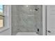 Well-lit bathroom featuring a bathtub with neutral tile, ideal for relaxation and comfort at 12484 Green Oak Ln, Dade City, FL 33525