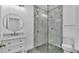 Modern bathroom with a glass shower door, beautiful tile, and neutral color palette creates a serene atmosphere at 12484 Green Oak Ln, Dade City, FL 33525