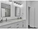 Bright bathroom with dual sinks, modern fixtures, and a decorative flower arrangement at 12484 Green Oak Ln, Dade City, FL 33525