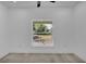 Bright bedroom with large window offering natural light and street views at 12484 Green Oak Ln, Dade City, FL 33525