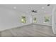 Spacious bedroom with wood floors, modern ceiling fan and plenty of natural light from three windows at 12484 Green Oak Ln, Dade City, FL 33525