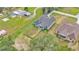 Aerial view showcasing a well-maintained house with a lush green yard at 12484 Green Oak Ln, Dade City, FL 33525