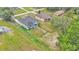 An aerial view showing the house with green grass and many trees at 12484 Green Oak Ln, Dade City, FL 33525