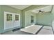 The entry way of the property has a covered porch with a ceiling fan and double doors at 12484 Green Oak Ln, Dade City, FL 33525