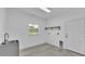 Functional laundry room with modern sink, storage shelves, and convenient door access at 12484 Green Oak Ln, Dade City, FL 33525