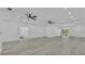 Spacious living room with ceiling fans and views of the kitchen and backyard at 12484 Green Oak Ln, Dade City, FL 33525