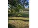 Large backyard with mature trees offers ample space for recreation and relaxation at 37906 Tucker Rd, Zephyrhills, FL 33542