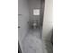Bright bathroom features modern marble tile floor, white walls, and a sleek toilet at 37906 Tucker Rd, Zephyrhills, FL 33542