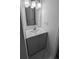 Bathroom featuring gray vanity, a mirror, and modern fixtures in a compact space at 37906 Tucker Rd, Zephyrhills, FL 33542