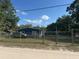 Fenced property with a well-maintained yard and a cozy home featuring durable siding at 37906 Tucker Rd, Zephyrhills, FL 33542