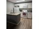 Bright kitchen featuring white appliances, gray walls, and a center island with a sink at 37906 Tucker Rd, Zephyrhills, FL 33542