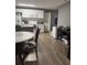 Well-equipped kitchen with white cabinetry, modern appliances, and laminate flooring for easy maintenance at 37906 Tucker Rd, Zephyrhills, FL 33542