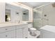 Bright bathroom with a glass-enclosed shower, white cabinets and vanity at 605 Sutton Pl # 102, Longboat Key, FL 34228