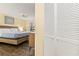 Comfortable bedroom featuring wood-look floors and ample closet space at 605 Sutton Pl # 102, Longboat Key, FL 34228