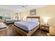 Bright bedroom featuring rustic furniture, wood-look floors, and a mirrored wall at 605 Sutton Pl # 102, Longboat Key, FL 34228
