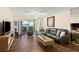 Inviting living room showcasing hard wood floors, and a comfortable seating area at 605 Sutton Pl # 102, Longboat Key, FL 34228