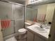 Bathroom featuring a shower/tub with sliding glass door and a single sink vanity at 3232 Lake Pine E Way # G1, Tarpon Springs, FL 34688