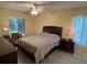 Cozy bedroom featuring a comfortable bed, natural light, and a functional workspace at 3232 Lake Pine E Way # G1, Tarpon Springs, FL 34688