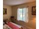 Comfortable bedroom with a window, two wall decorations and a comfy pillow at 3232 Lake Pine E Way # G1, Tarpon Springs, FL 34688