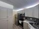 Contemporary kitchen with stainless steel appliances, sleek cabinets, and stylish backsplash at 3232 Lake Pine E Way # G1, Tarpon Springs, FL 34688