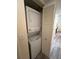A stacked washer and dryer unit enclosed with louvered doors at 3232 Lake Pine E Way # G1, Tarpon Springs, FL 34688
