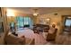 Spacious living room featuring a comfortable sofa, stylish decor, and a screened in porch at 3232 Lake Pine E Way # G1, Tarpon Springs, FL 34688
