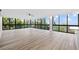 Inviting living room featuring beautiful flooring and walls of windows showcasing lush greenery at 3301 Bayshore Blvd # 503, Tampa, FL 33629
