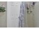 Clean, well-lit bathroom featuring a door and shower with marble patterned curtain at 3432 Monticello St, Holiday, FL 34690