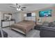 Bedroom featuring a cozy bed, large dresser, TV, and ceiling fan for relaxing evenings at 3432 Monticello St, Holiday, FL 34690