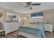 Bright bedroom featuring wood floors, ceiling fan, and a large dresser with ample storage space at 3432 Monticello St, Holiday, FL 34690