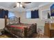 Comfortable bedroom with a decorative metal bed frame and natural light at 3432 Monticello St, Holiday, FL 34690