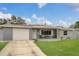 Lovely single-story home with a green lawn, and a quaint front porch at 3432 Monticello St, Holiday, FL 34690