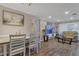 Open-concept living and dining area with hardwood floors and neutral decor at 3432 Monticello St, Holiday, FL 34690