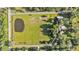 An overhead view showcases a rectangular property with a pond and a home and outbuildings at 4142 El Shaddiai Sq, Plant City, FL 33565