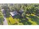 Aerial view of property featuring fenced pasture, red barn and residential home at 4142 El Shaddiai Sq, Plant City, FL 33565