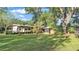 Expansive backyard featuring a trailer, screened porch, and mature trees offering shade and privacy at 4142 El Shaddiai Sq, Plant City, FL 33565