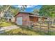 Exterior shot of a barn with a wooden fence and greenery at 4142 El Shaddiai Sq, Plant City, FL 33565