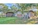 A rustic barn with a red sliding door and a weathered exterior, adding character to the property at 4142 El Shaddiai Sq, Plant City, FL 33565