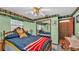 Spacious bedroom with fun patterned walls, ceiling fan and closet at 4142 El Shaddiai Sq, Plant City, FL 33565