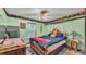 Bedroom featuring a bed, windows, and quirky wall art at 4142 El Shaddiai Sq, Plant City, FL 33565