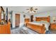 Cozy bedroom with a wood bed frame, neutral walls, and a ceiling fan for added comfort at 4142 El Shaddiai Sq, Plant City, FL 33565