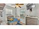 Comfortable bedroom featuring a ceiling fan, natural light, and a large recliner at 4142 El Shaddiai Sq, Plant City, FL 33565