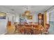 Traditional dining room with a chandelier and wooden dining set creates a warm, inviting atmosphere at 4142 El Shaddiai Sq, Plant City, FL 33565