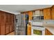 Kitchen area with stainless appliances and dark wooden cabinets at 4142 El Shaddiai Sq, Plant City, FL 33565